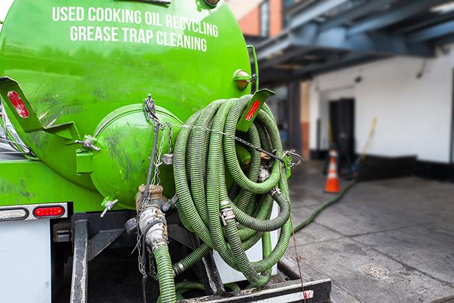 a vacuum truck pumping out a large underground grease trap in Grover Beach CA